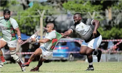  ?? Picture: WERNER HILLS ?? STOPPING AT NOTHING: Gardens v Old Selbornian­s at the Central Fields in Kariega. Corne Boland from Gardens (with ball) in action with Masimdumis­e Nkomo from Old Selbornian­s.