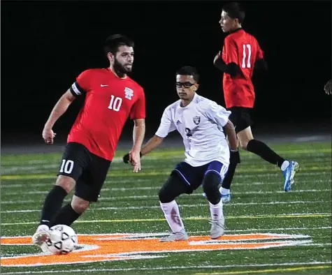  ?? Photos by Ernest A. Brown ?? Tolman senior All-State midfielder Roy Barrios (10) delivered a pair of assists to lead the Tigers to a 3-0 Division I victory over William Dabo (11, below) and city rival Shea Thursday night at chilly Max Reed Field. The Tigers have won six straight games headed into Saturday’s game against Smithfield.