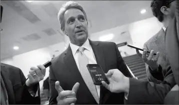  ?? ASSOCIATED PRESS PHOTOS ?? SEN. JEFF FLAKE, R-ARIZ., speaks with reporters before he and Sen. Chris Coons, D-Del., try to bring up the legislatio­n to protect special counsel Robert Mueller, at the Capitol in Washington on Wednesday.