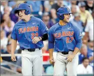  ?? AP/NATI HARNIK ?? Florida designated hitter Nelson Maldonado (right) celebrates with JJ Schwarz after scoring on a ground-rule double in the fourth inning Monday against LSU in Omaha, Neb.