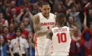  ?? TONY TRIBBLE - THE ASSOCIATED PRESS ?? Dayton’s Obi Toppin (1) and Jalen Crutcher (10) celebrate during the second half of an NCAA college basketball game against George Washington, Saturday, March 7, 2020, in Dayton, Ohio.