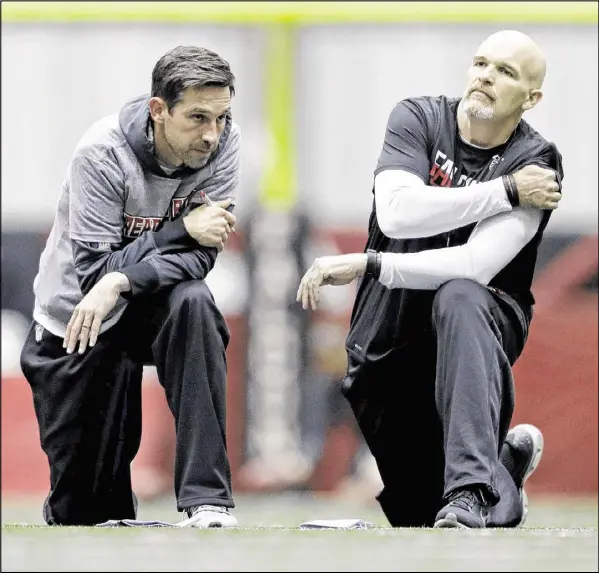  ?? DAVID GOLDMAN / ASSOCIATED PRESS ?? Offensive coordinato­r Kyle Shanahan (left, with Falcons head coach Dan Quinn) is expected to take over the top job in San Francisco after his duties at the Super Bowl are done. If Shanahan accepts the 49ers position, it could be part of a power-sharing...