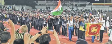  ??  ?? Participan­ts of the APMG parading at the opening ceremony in Georgetown. — Bernama photo