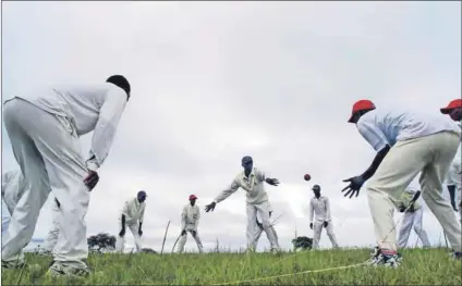  ??  ?? Catch: Members of the Fight Again village cricket team (above) train in the Eastern Cape. Tournament­s such as ‘Amacal’egusha’ (half a sheep) have been played since the 1920s between villages, and children (left) also love the game. Photos: Reuters/Mike Hutchings