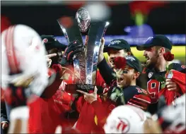  ?? CHASE STEVENS — THE ASSOCIATED PRESS FILE ?? Utah players celebrate with the trophy after their victory over Oregon to win the Pac-12 Conference championsh­ip in December. The Pac-12 announced it was scrapping its divisional format for the coming season on Wednesday.