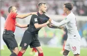  ?? FRANK AUGSTEIN — THE ASSOCIATED PRESS ?? Croatia’s Ivan Rakitic, center, and England’s Dele Alli, right, are separated by referee Cuneyt Cakir on Wednesday.