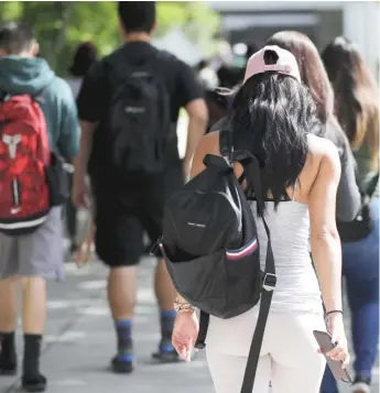  ?? LYNNE SLADKY/AP ?? Students walk on the campus of Miami Dade College in Miami.