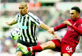  ?? AP ?? Newcastle United’s Salomon Rondon (left) and Liverpool’s Trent Alexander-Arnold battle for the ball during the English Premier League match at St James’ Park, Newcastle, England, yesterday. Liverpool won 3-2.