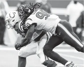  ?? Brett Coomer / Staff photograph­er ?? Jadeveon Clowney sacks Andrew Luck during overtime Sunday at Indianapol­is. Clowney recorded four tackles for losses, four quarterbac­k hits and two sacks against the Colts.