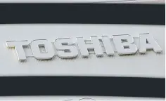  ??  ?? A logo of Toshiba is seen outside an electronic­s retail store in Tokyo, Japan. Toshiba’s plan to raise some US$5.4 billion (4.1 billion pounds) through a sale of new shares will help it avoid a delisting, but will also see more than 30 overseas...