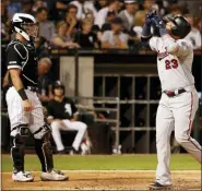  ?? JEFF HAYNES — THE ASSOCIATED PRESS ?? Minnesota Twins’ Nelson Cruz points to the sky at home plate after hitting his third home run of the game during the fifth inning of a baseball game as Chicago White Sox catcher James McCann, left, looks on Thursday in Chicago.