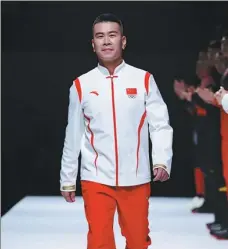  ?? PROVIDED TO CHINA DAILY ?? Han Xiaopeng, China’s first Olympic champion in a snow event, hits the catwalk in Team China’s podium uniform for next month’s Winter Olympics, at Friday’s launch event in Beijing.