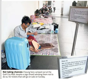  ??  ?? Not taking chances: Cheung fans camped out at the Quill City Mall, despite a sign (inset) advising them not to do so, for tickets that will go on sale on Sunday.