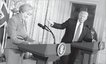  ?? Mandel Ngan AFP/Getty Images ?? PRESIDENT TRUMP speaks at a news conference with British Prime Minister Theresa May. May made a special point of saying that Trump had affirmed in their private meeting that he was “100% behind NATO.”