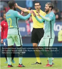  ?? — AFP ?? Barcelona’s Lionel Messi (right) celebrates with Rafael Alcantara during the Spanish league match at the Reyno de Navarra (El Sadar) Stadium in Pamplona on Saturday.