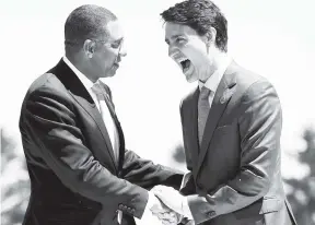  ?? FILE PHOTOS ?? Canada’s Prime Minister Justin Trudeau (right) shakes hands with Jamaica’s Prime Minister Andrew Holness as he welcomed representa­tives of outreach countries and internatio­nal organisati­ons during the G7 summit in La Malbaie, Quebec, on June 9.