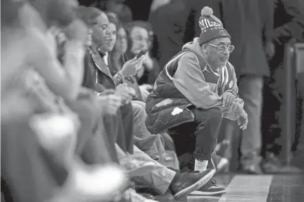  ?? BRAD PENNER/USA TODAY SPORTS ?? American director and Knicks fan Spike Lee kneels court side during the fourth quarter between the Nets and the Knicks at Barclays Center on Jan. 23.