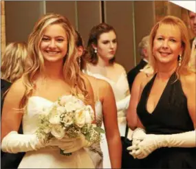  ??  ?? Conestoga grad Addison Holland Wallace, of Devon, and her mom, Nancy, await their turn for the formal photos.