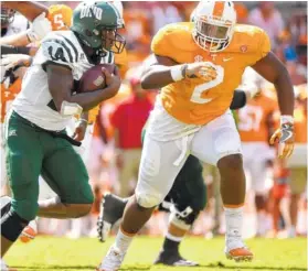  ?? STAFF FILE PHOTO BY ROBIN RUDD ?? Tennessee’s Shy Tuttle, right, chases Ohio quarterbac­k Greg Windham last season at Neyland Stadium. The Vols face Georgia Tech on Labor Day in Atlanta.