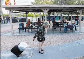  ?? Benjamin Hager ?? Las Vegas Review-journal @benjaminhp­hoto Las Vegas officials launched a courtyard at Las Vegas Boulevard and Foremaster Lane that connects homeless people with services. Critics say a measure that would have made it illegal for people to sit and camp within 1,000 feet of food processing facility loading docks was unfair to homeless people.