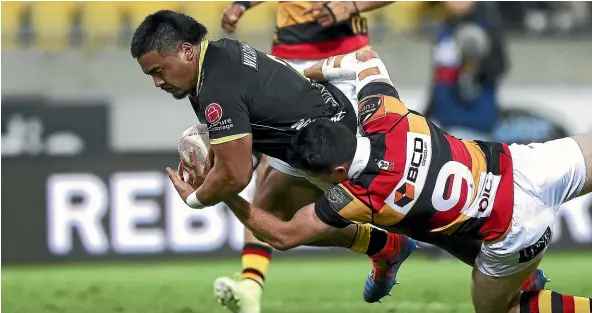 ?? GETTY IMAGES ?? Wellington’s Asafo Aumua scores in the tackle of Waikato’s Jack Stratto nlast night.