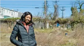  ?? BARBARA HADDOCK TAYLOR/STAFF ?? Nicole Earle, CEO of Dominion Real Estate, stands in a vacant lot on Park Heights Avenue where her company is building 50 units of affordable housing.