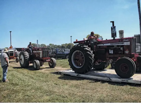  ??  ?? Each year, the Lewistown FFA Truck and Tractor Pull gets started at noon, and on a Sunday. Just before kick-off, the 11,000-pound Farm Stocks lined up to roll across the portable scales positioned at the far side of the pits. By the time the day was through, more than 150 hooks would take place at the Fulton County Fairground­s.