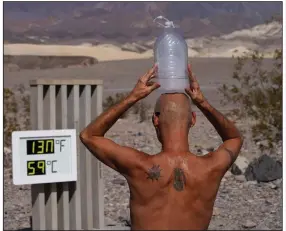  ?? (AP/John Locher) ?? Steve Krofchik cools off with a jug of ice water Monday at Death Valley National Park in California. More photos at arkansason­line.com/819record/.