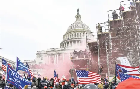  ?? TIMES KENNYHOLST­ON/THE NEWYORK ?? Supporters of President Donald Trump storm the U.S. Capitol in Washington, Jan. 6, 2021. They came from around the country, with different affiliatio­ns -- QAnon, Proud Boys, a few elected officials, many everyday Americans. One allegiance united them.