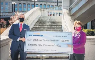  ?? SUBMITTED PHOTO ?? Mid Penn Bank President & CEO Rory G. Ritrievi, left, and PA Breast Cancer Coalition President & Founder Pat Halpin-Murphy met on the east side of the Pennsylvan­a State Capitol recently for a presentati­on of Mid Penn Bank’s $75,000 contributi­on to the PA Breast Cancer Coalition’s efforts in the ongoing fight against breast cancer.