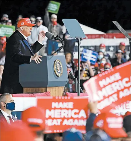  ?? ALEX BRANDON/AP ?? President Trump campaigns Wednesday night at a rally at the Des Moines Internatio­nal Airport in Iowa. Earlier, Joe Biden in remarks hit at Trump’s handling of the pandemic.