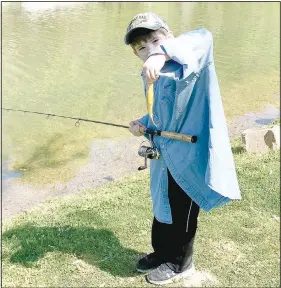  ??  ?? Cade Winkelmann shows off the fish he helped land during a fishing trip to Lake Ann in Bella Vista. (NWA Democrat-Gazette/Sally Carroll)