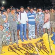  ?? PTI ?? Security personnel with the weapons seized after an encounter.