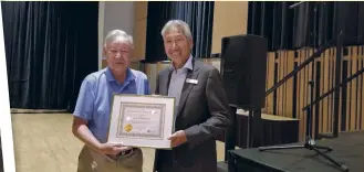  ??  ?? From left: Roy and his family back in 1940 in Ocean Falls, B.C.; in 2019,
Gary Kawaguchi (right) of the Japanese Canadian Cultural Centre in Toronto, giving Roy an award for his volunteer service in the Japanese archives.