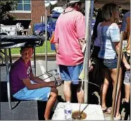  ?? PETER HVIZDAK / HEARST CONNECTICU­T MEDIA ?? Milford, Connecticu­t: Saturday. Hudson Bombery, 10, of Naugatuck, beats the heat and finds some shade under an oyster shucking table Saturday afternoon at the Milford Oyster Festival in Milford.