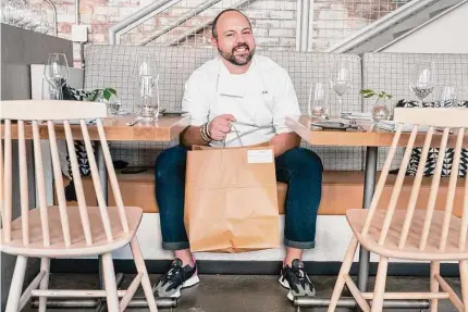  ?? Jacquelyn Martin/Associated Press ?? Matt Baker, chef and owner of Gravitas, inside the restaurant, on Feb. 14 in Washington. Gravitas has a subscripti­on service offering a monthly meal for two.