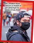  ??  ?? A London man wears a mask in an attempt to stay virus-free