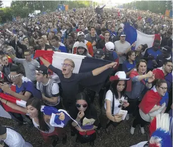  ?? DOMINIQUE FAGET/AFP/GETTY IMAGES ?? France’s fans watch the Euro 2016 Group A football match between France and Switzerlan­d on Sunday near the Eiffel Tower.