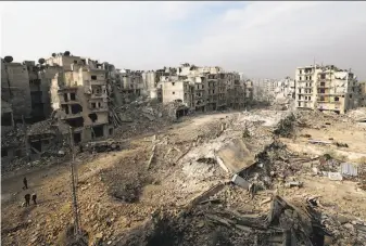  ?? Hassan Ammar / Associated Press ?? The view from the balcony of the apartment where Abdul-Hamid Khatib and his family live in eastern Aleppo, Syria, shows the scale of the devastatio­n in an area once held by rebel forces.