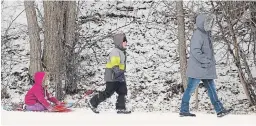  ?? CLIFFORD SKARSTEDT EXAMINER ?? A family goes sledding at Jackson Park pond on Friday. Health profession­als say it’s important to stay physically active during the stayat-home order.