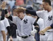  ?? JULIO CORTEZ — ASSOCIATED PRESS ?? Clint Frazier, center, is congratula­ted by teammates, including Aaron Judge, right, after hitting three-run walkoff home run during Yankees’ victory over Brewers on Saturday.
