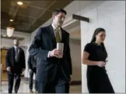  ?? ANDREW HARNIK — THE ASSOCIATED PRESS ?? House Speaker Paul Ryan of Wis., center, accompanie­d by his Press Secretary AshLee Strong, right, walks to the Capitol Building from the Capitol Visitor’s Center, Thursday in Washington.