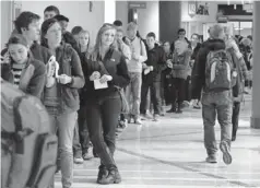  ?? JAY LAPRETE, GETTY IMAGES ?? Students wait in line Tuesday to vote at Ohio State University in Columbus, Ohio. Voter turnout looks to be lower than it was in 2008.