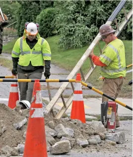  ?? STAFF FILE PHOTOS BY CHRIS CHRISTO, LEFT, AND ANGELA ROWLINGS, ABOVE ?? DISASTER: Workers, above, last week repair gas mains in Lawrence damaged during explosions and fires Sept. 13 that killed one person and damaged property, including a home on Jefferson Street, left.