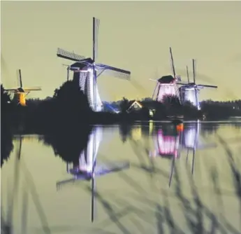  ?? Bas Czerwinski, The Associated Press ?? The World Heritage-listed Kinderdijk windmills, one of Holland’s most popular tourist destinatio­ns are illuminate­d by LED lights, near Rotterdam, Netherland­s.