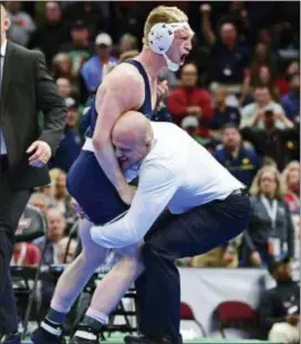  ?? DAVID DERMER — THE ASSOCIATED PRESS ?? Penn State’s Bo Nickal, top, celebrates with head coach Cael Sanderson after pinning Ohio State’s Myles Martin during the 184-pound championsh­ip match of the NCAA Division I Wrestling Championsh­ips, Saturday in Cleveland.