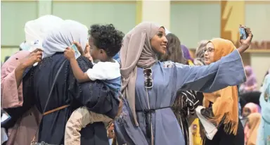  ?? PHOTOS BY BAILEY NETSCH/THE REPUBLIC ?? A woman takes a selfie to show off her Eid attire Tuesday in Phoenix.