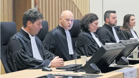  ?? AFP ?? President of the court Steenhuis, second left, talks prior to verdict in the trial of four men prosecuted for their involvemen­t in the MH17 downing case, in Badhoevedo­rp on Thursday.