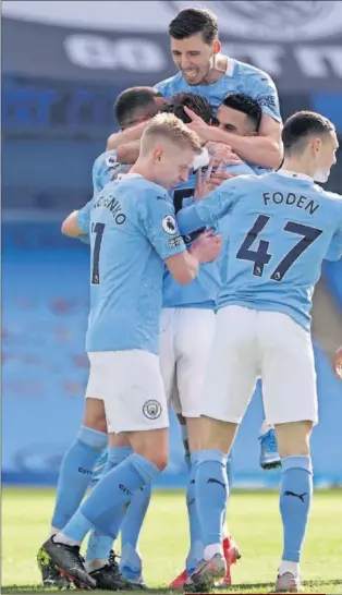  ??  ?? Ruben Dias, Fernandinh­o, Zinchenko, Mahrez, Foden y Walker abrazan a Stones tras marcar el 2-1 definitivo que otorgó al City la victoria.