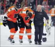  ?? TOM MIHALEK — THE ASSOCIATED PRESS ?? Flyers defenseman Andrew MacDonald, left, is the man injured now, expected to miss four to six weeks with a knee injury. Fellow defender Radek Gudas, here bowing in pain after getting hurt last April against the Devils, has a tough job ahead as new...